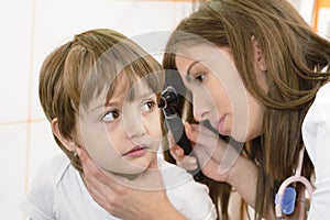 Otolaryngologist examining a kid ear