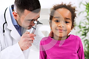 Otolaryngologist examining a kid ear