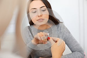 Otolaryngologist giving hearing aid to patient in hospital