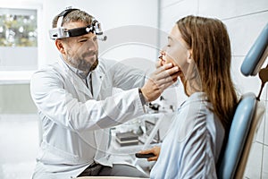 Otolaryngologist with patient in ENT office