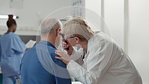Otolaryngology specialist using otoscope to examine ear infection