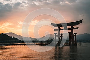 Otorii gate at Miyajima, Japan during sunset. photo