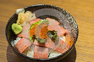 Otoro sashimi (raw tuna with fat) and salmon eggs on top of Japanese rice