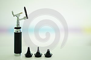 Otoscope for ear check for doctor ENT  with 3 sizes of specula pieces on blur background with copy space