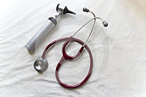 Otoscope and stethoscope together white background