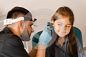 Otoscopy of child ears with otoscope. ENT doctor. Consultation with pediatric otolaryngologist. Treatment of childs ear