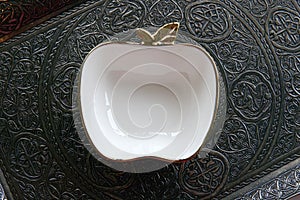 Ottoman style with delicate porcelain bowl in an apple shape