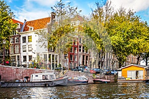 Oudeschans Canal with its historic canal houses and house boats, near the Montelbaans Tower in the center of Amsterdam
