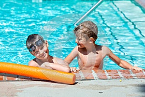 Oudoor summer activity. Concept of fun, health and vacation. A happy brothers boys eight and five years old in swimming