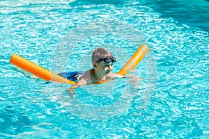 Oudoor summer activity. Concept of fun, health and vacation. Happy smiling boy eight years old in swim glasses swim in