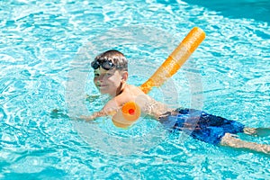 Oudoor summer activity. Concept of fun, health and vacation. Happy smiling boy eight years old in swim glasses swim in