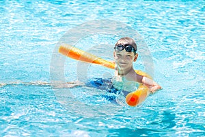 Oudoor summer activity. Concept of fun, health and vacation. Happy smiling boy eight years old in swim glasses swim in