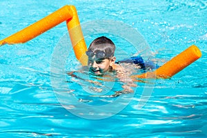 Oudoor summer activity. Concept of fun, health and vacation. Happy smiling boy eight years old in swim glasses swim in