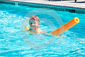 Oudoor summer activity. Concept of fun, health and vacation. Happy smiling boy five years old in swim glasses swim in