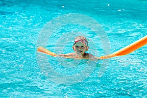 Oudoor summer activity. Concept of fun, health and vacation. Happy smiling boy five years old in swim glasses swim in