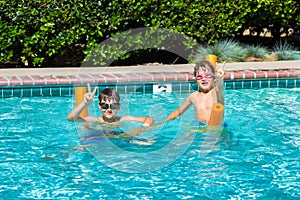 Oudoor summer activity. Concept of fun, health and vacation. Happy smiling boys eight and five years old in swim glasses
