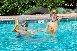 Oudoor summer activity. Concept of fun, health and vacation. Happy smiling boys eight and five years old in swim glasses