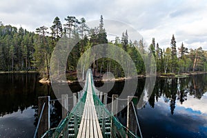 Oulanka National Park. Small hiking trail with a hanging bridge near Kuusamo, Northern Finland