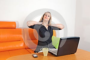 Oung businesswoman giving herself a neck rub photo