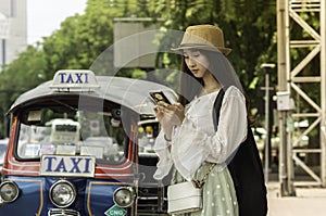 Asian Young lady tourist using a smart phone in the road looking some application map