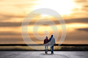 Ouple hand in hand with sundown plain background composing