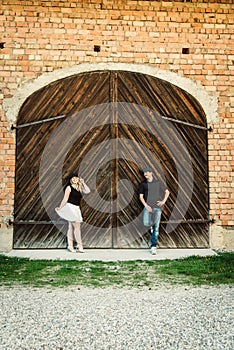 Ouple stands before old door