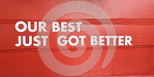 Our best just got better sticker di-cut white word sign on cement concrete red wall to guarantees the commitments with customer in