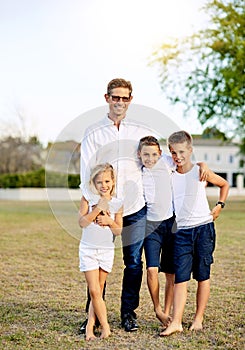 Our children teach us what life is all about. a happy family spending time together outdoors.