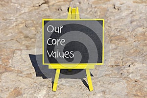 Our core values symbol. Concept words Our core values on black chalk blackboard on a beautiful stone background. Business and our