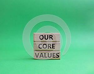 Our core values symbol. Concept words Our core values on wooden blocks. Beautiful green background. Business and Our core valu