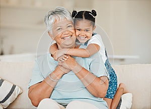 Our family is a circle of strength and love. a grandmother and granddaughter bonding on the sofa at home.