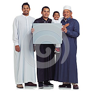 Our family message. Studio portrait of the male members of a muslim family holding up a blank sign isolated on white.
