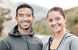 Our healthy hearts leads to happy lives. Portrait of a sporty young man and woman exercising outdoors.