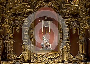 Our Lady of the Alcobilla, a small altar in the baroque style with a polychrome pottery representation of the Piety.