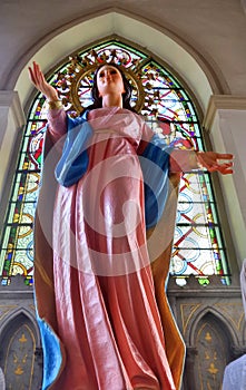 Our lady sculpture and colourful stainglass window in Rosary Kalawar Church Bangkok