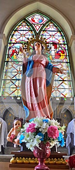 Our lady sculpture and colourful stainglass window in Rosary Kalawar Church Bangkok