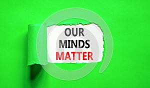 Our minds matter ourmindsmatter symbol. Concept words Our minds matter on beautiful white paper. Beautiful green background. Our photo