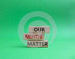 Our Minds Matter symbol. Concept words Our Minds Matter on wooden blocks. Beautiful green background. Psychological social and Our