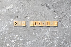 Our mission on word written on wood block. our mission text on table, concept
