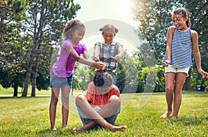 He is our prisoner. adorable children playing with water balloons outdoors.