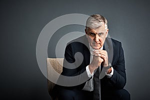 Our purpose is to achieve grand things. Studio shot of a mature businessman posing against a grey background.