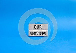 Our services symbol. Concept words Our services on wooden blocks. Beautiful blue background. Business and Our services concept.