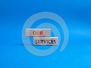 Our services symbol. Concept words Our services on wooden blocks. Beautiful blue background. Business and Our services concept.