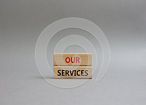 Our services symbol. Concept words Our services on wooden blocks. Beautiful grey background. Business and Our services concept.