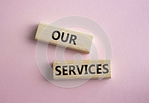 Our services symbol. Concept words Our services on wooden blocks. Beautiful pink background. Business and Our services concept.