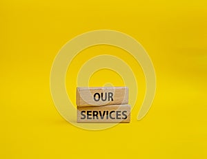 Our services symbol. Concept words Our services on wooden blocks. Beautiful yellow background. Business and Our services concept.