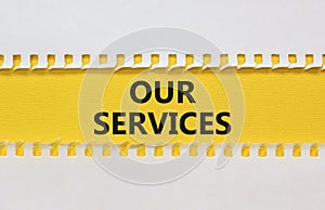 Our services symbol. White and yellow paper with words `Our services`. Beautiful yellow background. Business and our services