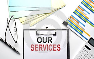 OUR SERVICES text on paper sheet with chart,color paper and calculator