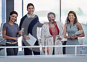 Our success depends on all of us working together. Portrait of a group of smiling colleagues working together in an