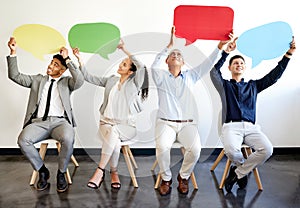 These are our thoughts. a group of businesspeople holding speech bubbles in an office at work.